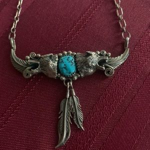 Cool looking turquoise necklace! Has two wolves on each side!
